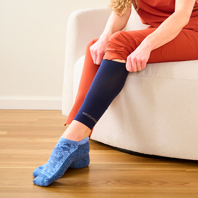 No Show Duo Set: Calf Sleeves and Performance Anklet set in blue worn on foot, with a woman pulling the calf sleeve up.