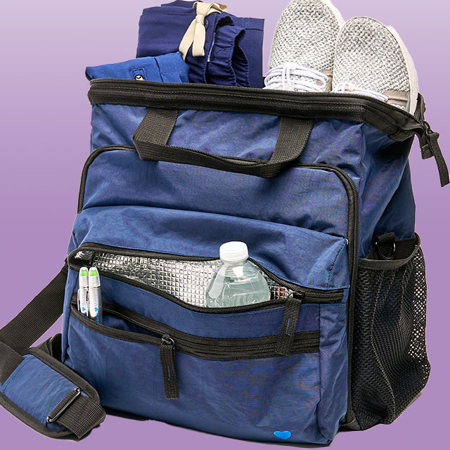 The New Ultimate Nursing bag shown in blue with scrubs, shoes and a water bottle poking out.