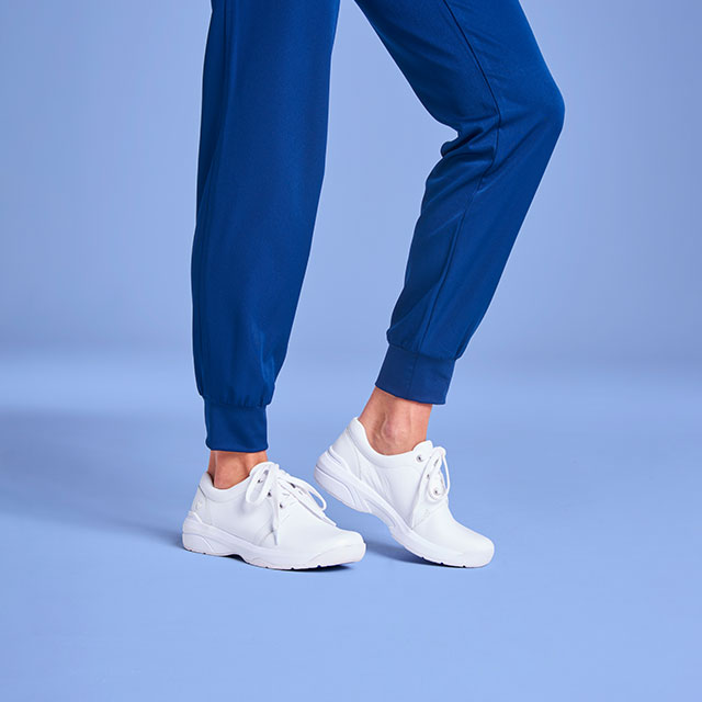 Women’s Corby lace-up sneaker in white worn on foot.