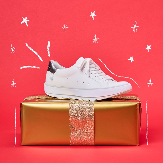 Women’s Calliope in White shown sitting on a gold wrapped present. Shop Under $100 Gift Guide.