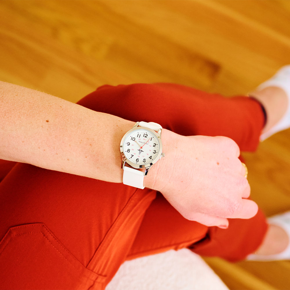 Nurse Mates Brand Partner Ella Eastin wearing the Sweep Watch in white and Sustainable No Show Liners in multicolor.